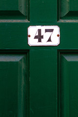 House number 47 on a dark wooden front door