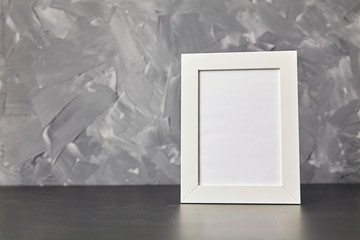 Photo frame on wood table. On gray background with copy space