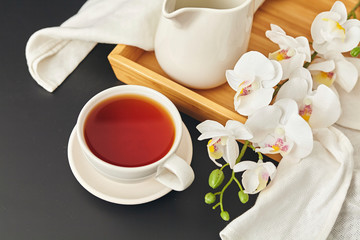 Bamboo tray with mug, napkin and flower. Copy space.