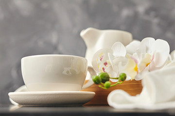 Obraz na płótnie Canvas Bamboo tray with mug, napkin and flower. Copy space.