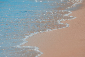 beach with blue water and pink sand