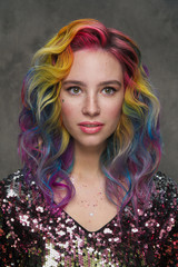 Portrait of a beautiful young girl with dyed colored hair. Hairstyle and makeup. Fashion shooting...