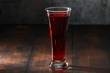 Red juicy drink in a high beer glass	
