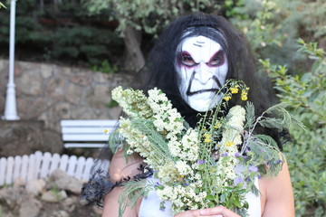 Spooky bride holding a bouquet 