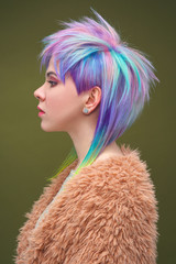 Portrait of a beautiful young girl with dyed colored hair. Hairstyle and makeup. Fashion shooting...