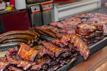 Chef preparing meat on the grill, during outdoor outside food festival