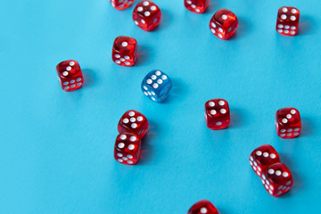 Bright red dice on blue background, difference