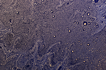 Acrylic Fluid Art. Gold particles pattern on dark blue background. Star dust. Abstract space background or texture