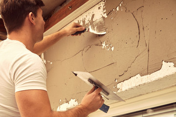 Construction worker plaster a wall.