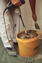 Construction worker plaster a wall.