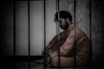 Asian man desperate at the iron prison,prisoner concept,thailand people,Hope to be free,Serious...
