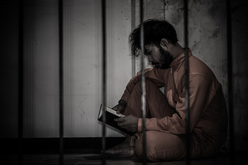 Asian man desperate at the iron prison,prisoner concept,thailand people,Hope to be free,Serious...