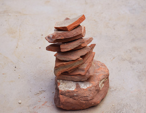 Indian Childhood Village Game named as Pitthoo in Hindi where a person has to hit the brick pieces with a ball