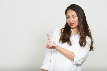 Portrait of stressed young Asian businesswoman looking disgusted