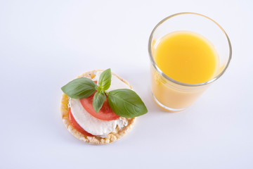basil, tomato, mozzarella on a corn wafer and orange juice