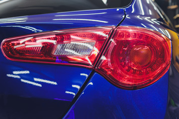 Red taillight of a modern car close-up. Service, repair, body repair, body painting, spare parts...