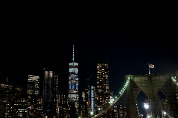Fototapeta na wymiar Brooklyn bridge during nighttime american flag