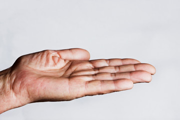 Grandmother's old palm close up. Wrinkles on grandma's old hands. Good aged mother. Appreciate the parents. Caring and caring for the elderly. The hardworking hands of an old grandmother on a white