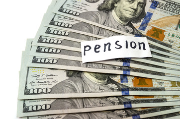 Retirement income concept. Dollars on a white background. Pension inscription on a white sticker.