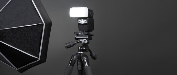 Studio light and back drop and soft box set up for shooting photo or video production which includes flashlight and continue lighting on tripod and paper background and used for photographer