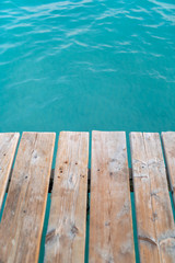Wooden dock texture with blue turquoise water in tropical island