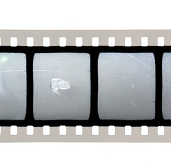 close up or macro photo of 35mm movie film strip on white background, just blend in your content to...