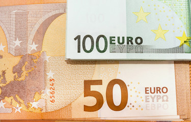 50 and 100 euros, close-up. View from above. Money background.