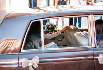 Shot of bride inside of vintage car going to wedding