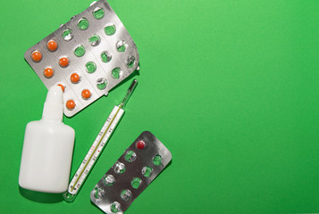 cold remedy, thermometer and packaging with pills