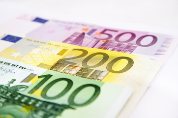 100, 200 and 500 euro banknotes on white. Close-up. Money background.