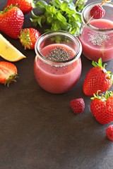 Berry smoothie with chia seeds on dark background, top view