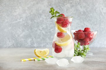 Raspberry infused water, coctail or lemonade. Summer iced cold drink with raspberry, lemon and...
