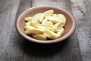 Dumplings. Potato and flour dumplings.
Appetizing dish on a wooden background.