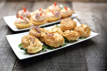 Dry puff stuffed with stuffing. Dry snacks.
Appetizing dish on a wooden background.