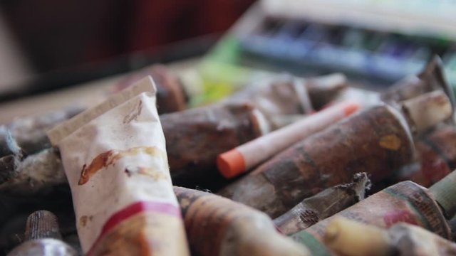 Old rusty tubes with paint and paint brushes. Tools for painter and artist.