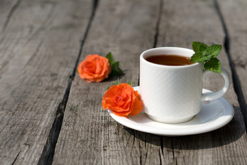 Flat lay Coffee composition  with  white cup    of coffe and  flower  and fresh leaf of mint
