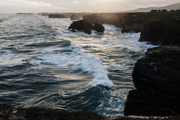 view of the waves against the background of the rising sun