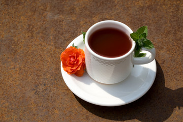 Flat lay Coffee composition  with  white cup  and orange  flower  and fresh leaf of mint