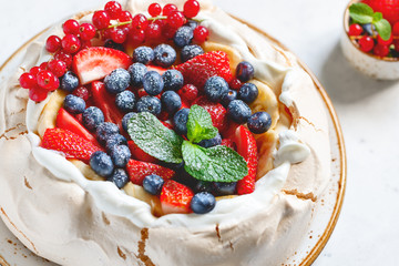 New Zealand Pavlova cake with whipped cream and mix of fresh berries