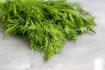 Fresh greens for salad. Parsley dill. Good for health, on a gray background. Warehouse of vitamins.