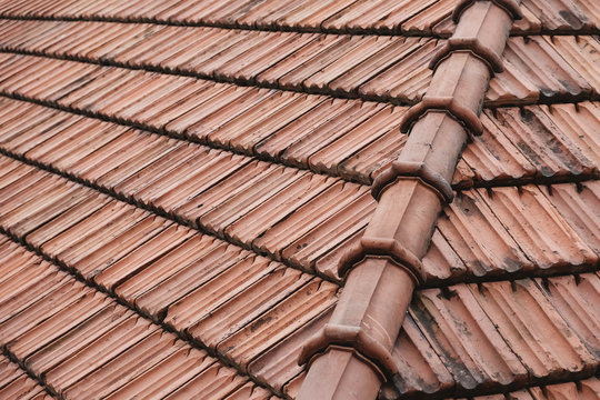 Old roof tiles on the roof of an house as a background image. Place for text or advertising