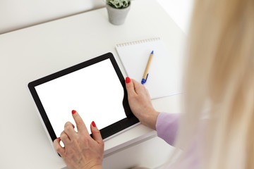 Business woman holding blank touch screen device.