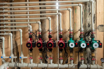 Distribution header of the heating system in the boiler room, with circulation pumps