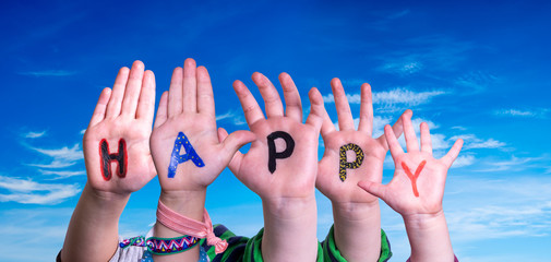 Children Hands Building Colorful English Word Happy. Blue Sky As Background