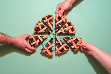 Grabbing slices of blueberry cake top view.