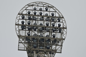 
stadium floodlight against a cloudy sky