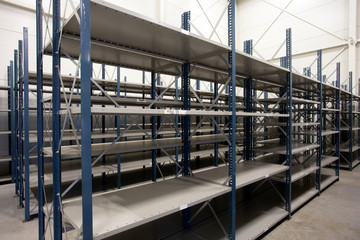 huge warehouse with empty racks inside for storage modern design, metal shelves for distribution