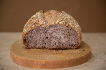 unusual craft bread with lilac-colored pulp on a brown background with copy space