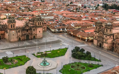 Aerial close up over Plaza de Armas, The Cathedral and Church of the Society of Jesus from Cusco,...