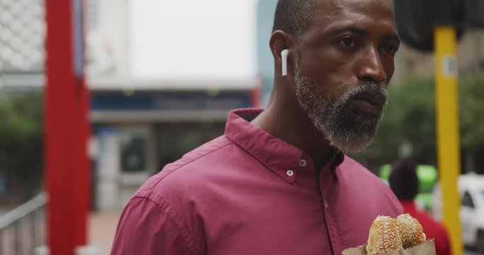 African American man eating in the street